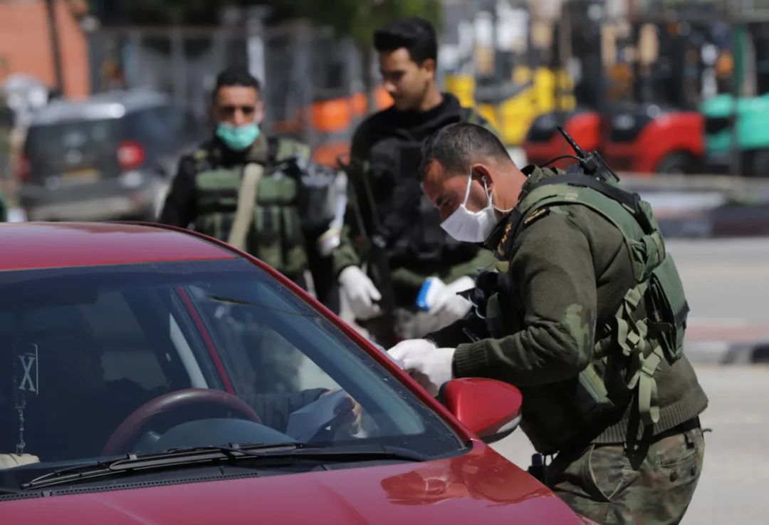 3月24日，在约旦河西岸城市希伯伦，巴勒斯坦警察在一处关卡检查来往车辆。新华社发（马蒙·沃兹沃兹摄）