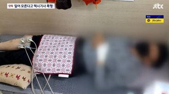 JTBC电视台报道截图：韩国司机受伤后在医院接受治疗
