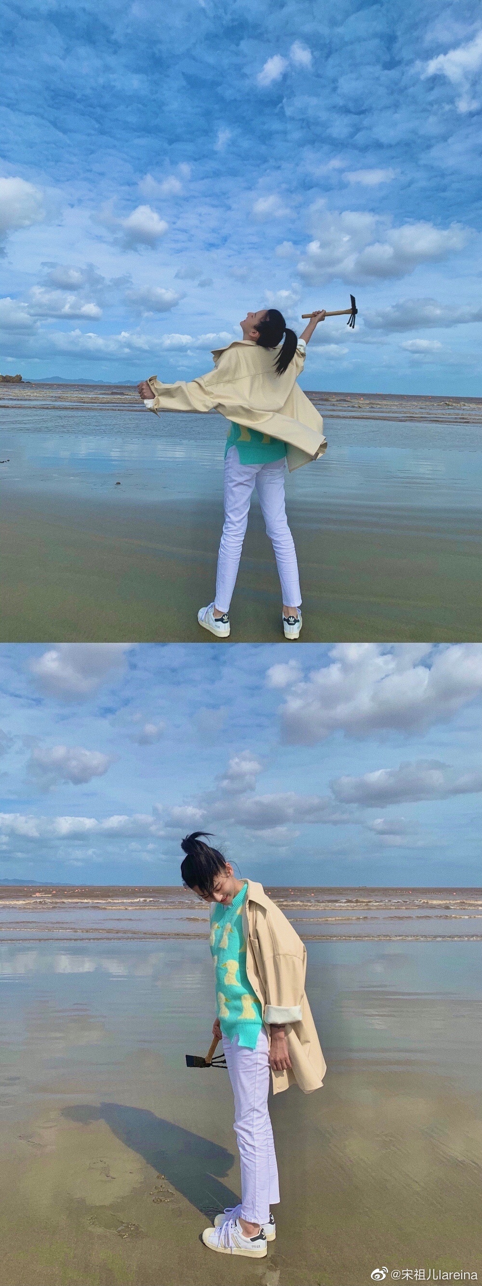 照片中宋祖儿在海边穿着湖蓝色小鸭毛衣,搭配牛仔裤和卡其色风衣,头发