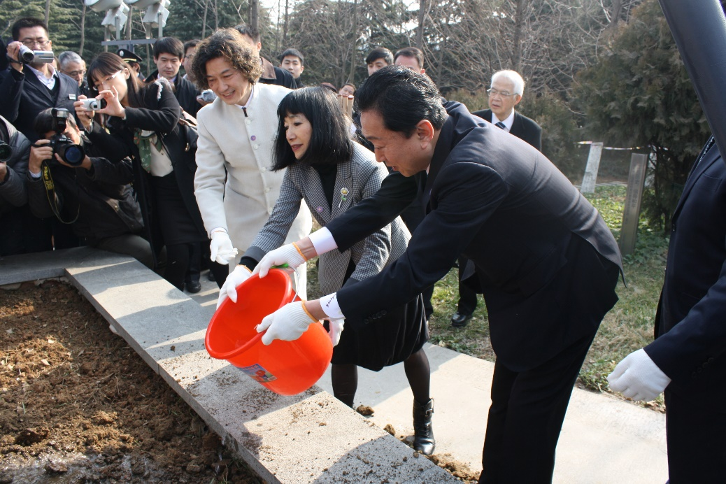 日本前首相鸠山夫妇在侵华日军南京大屠杀遇难同胞纪念馆内的和平公园里为和平之树浇水。