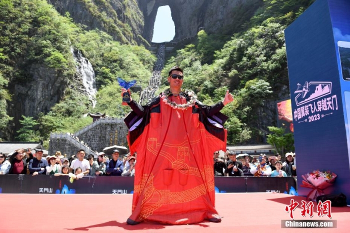 翼装飞行运动员张树鹏在天门洞下庆祝挑战成功。杨华峰 摄