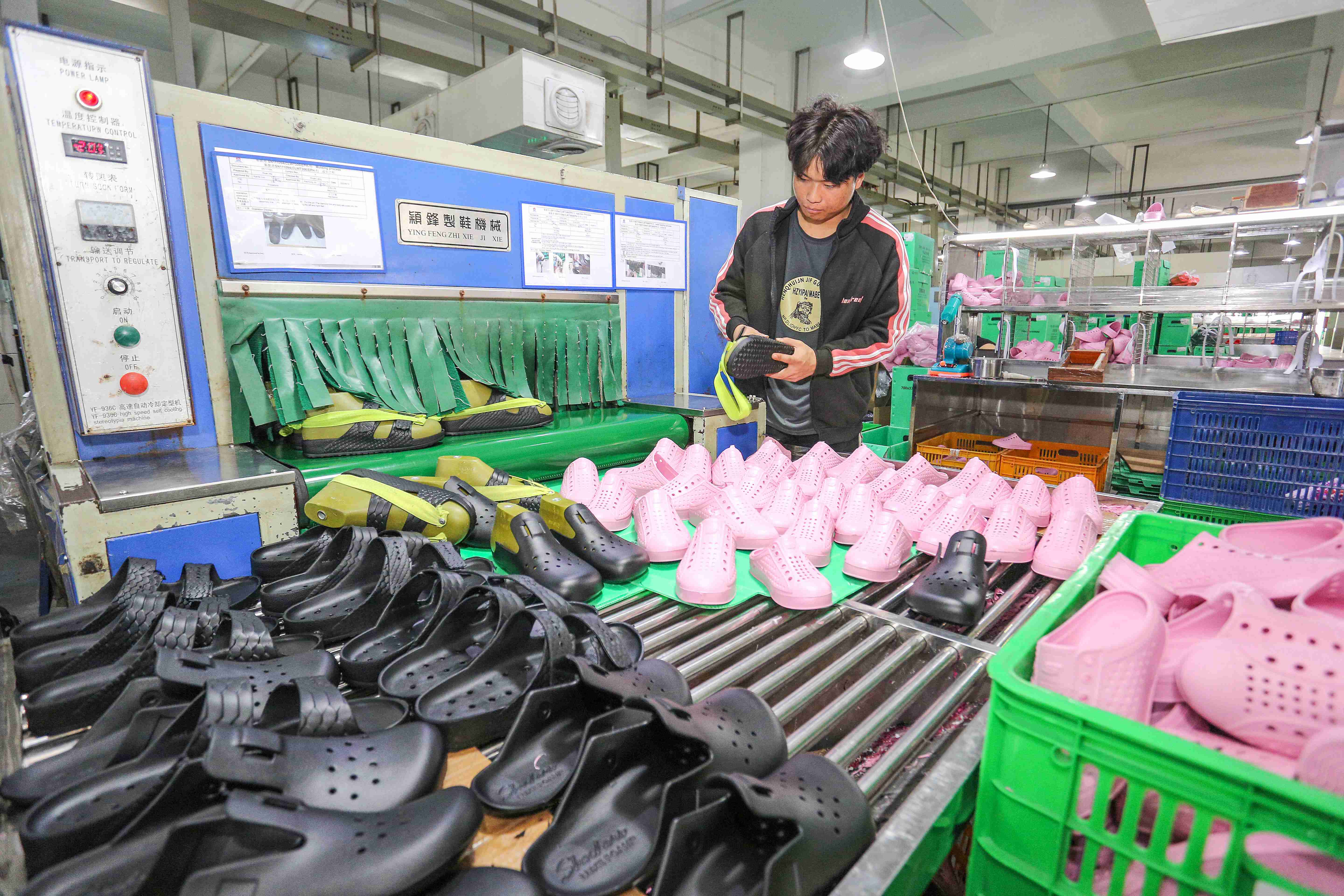 福建晋江,近期是凉鞋生产旺季,在福建晋江一鞋厂,工人正在生产线上