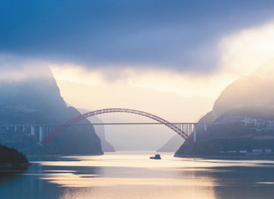 船舶行驶在晨曦中的三峡库区湖北省宜昌市秭归县水域。当地加强退耕还林、库岸修复、水土流失治理等生态工程建设，确保一库清水向东流。郑家裕摄（影像中国）