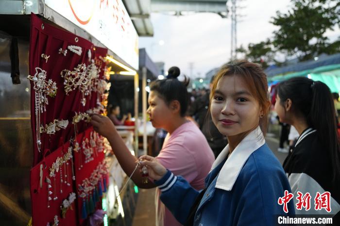 3月23日,缅甸工人在瑞丽沿边产业园胞波街逛街挑选饰品。中新社记者 刘冉阳 摄