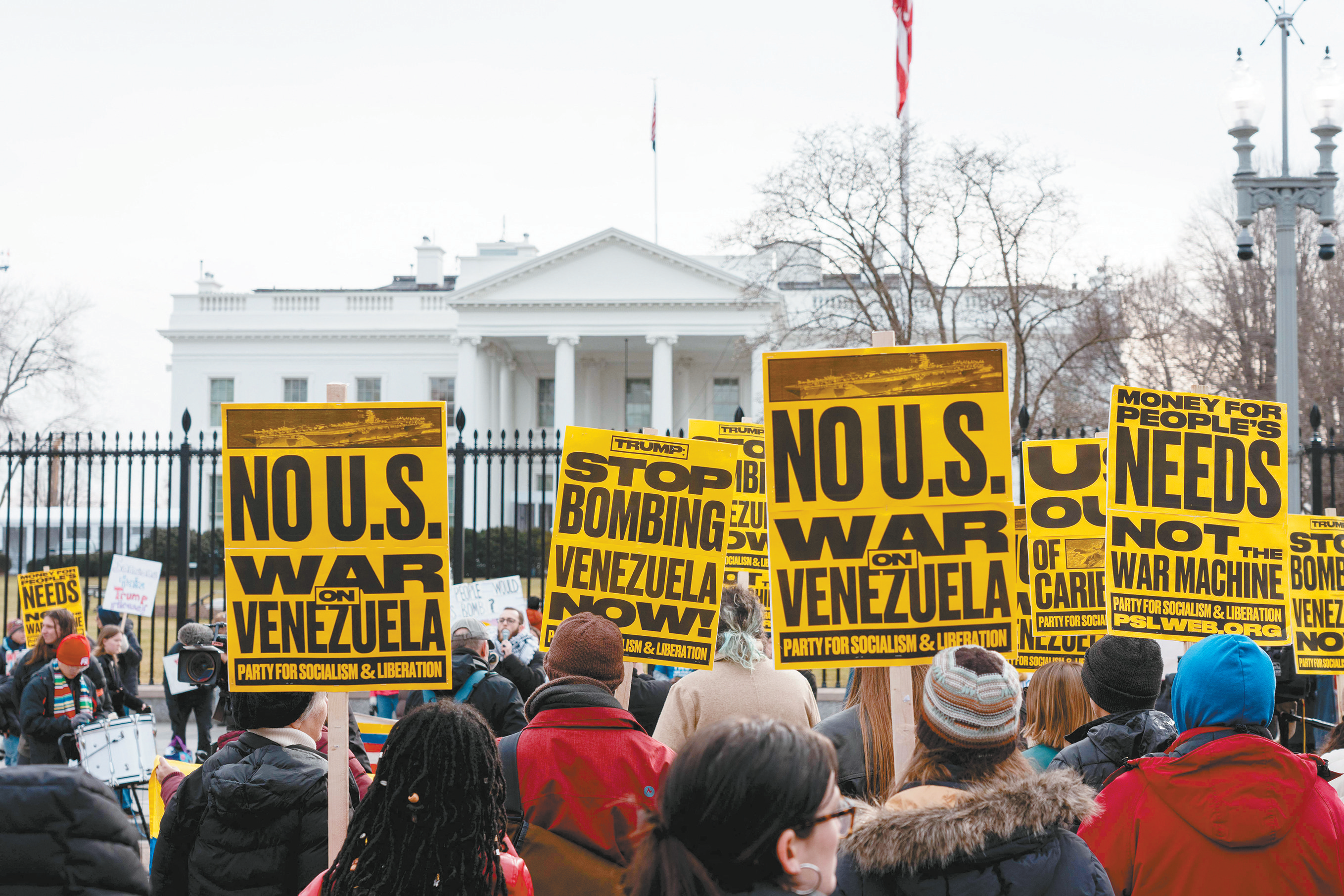 当地时间1月3日，抗议者在华盛顿白宫前手持标语，反对美国在委内瑞拉采取大规模军事行动。（视觉中国）