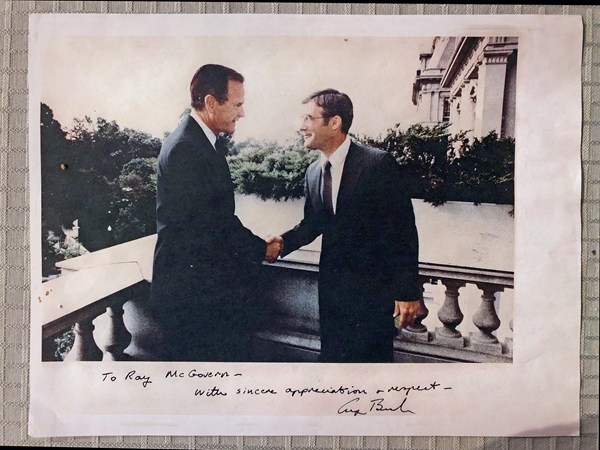 1985年，麦戈文在完成情报简报后，与时任美国副总统老布什握手。